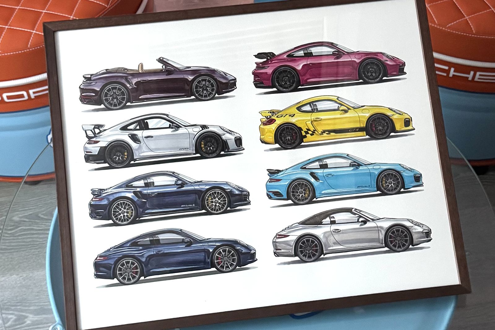 A dark-wood-framed print bringing together eight sports cars from one collection, in two columns.